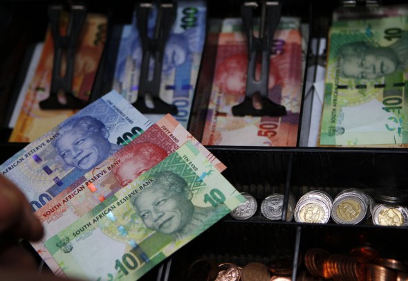 South Africa's new banknotes, which features an image of former president Nelson Mandela on the front and images of the country's "Big Five" wild animals on the reverse, are seen in a till as they go into official circulation in Pretoria